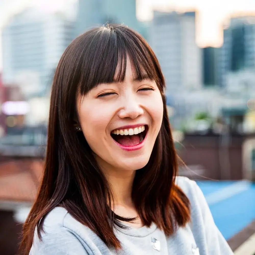 woman showing off her shiny hair after using the right Korean shampoo and conditioner