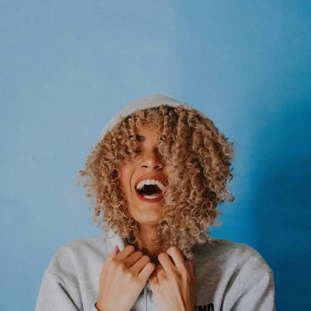 woman looking at her newly bleached hair