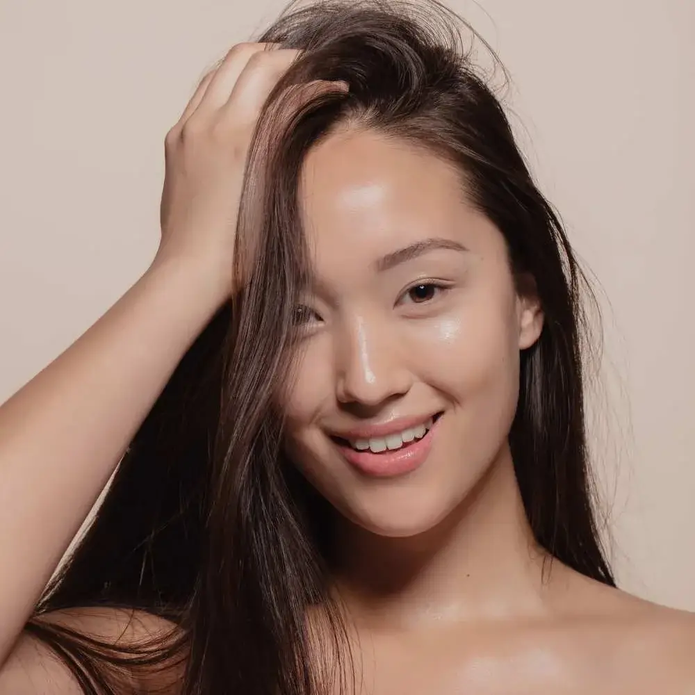Woman applying Korean shampoo as part of her hair care routine