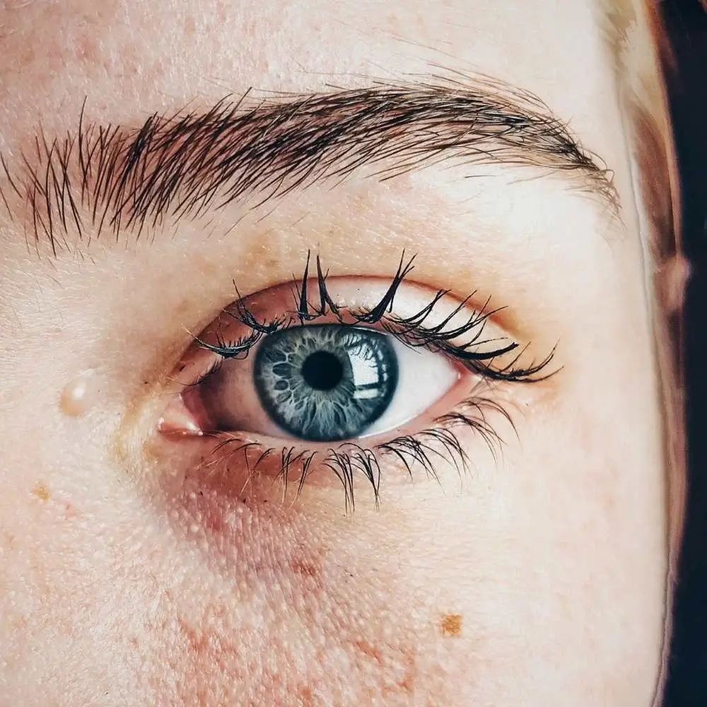 Woman with well-defined brows achieved with a microblade eyebrow pen.