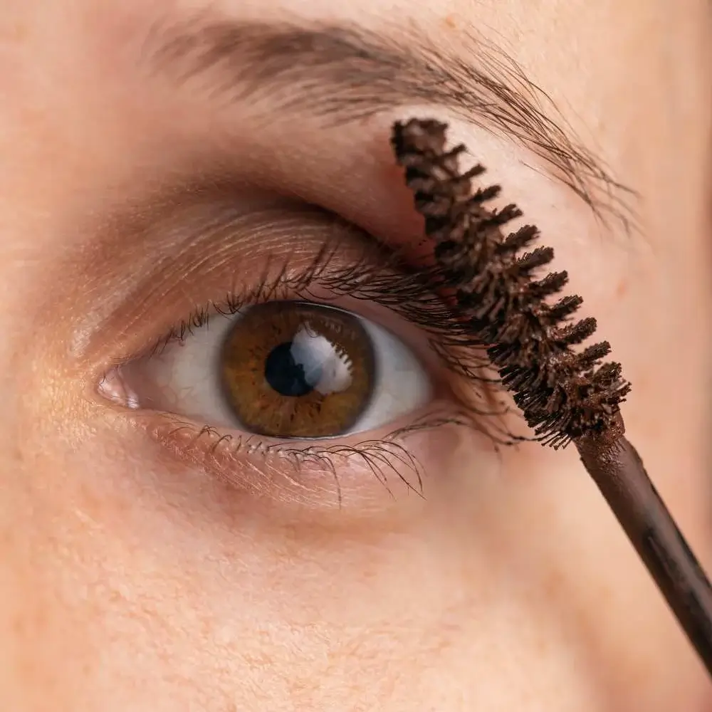Close-up image of a brown mascara wand showcasing its rich pigment