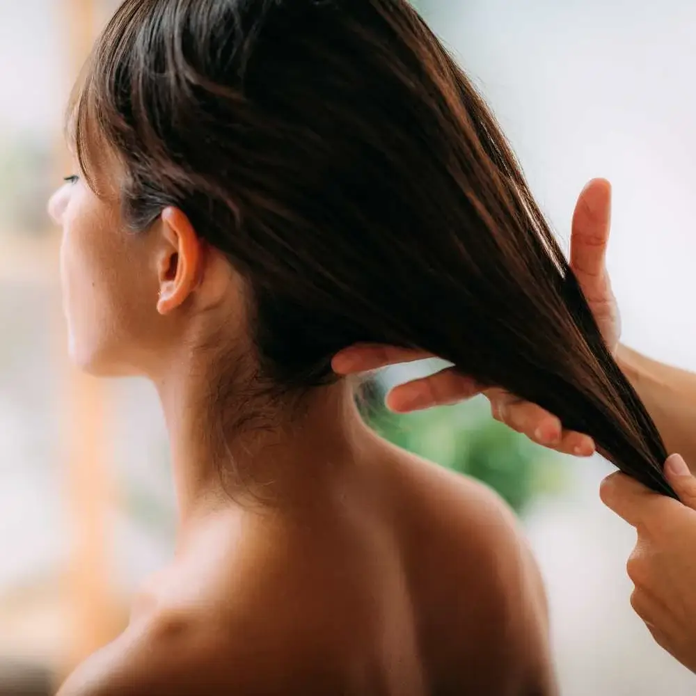 Applying coconut oil on hair