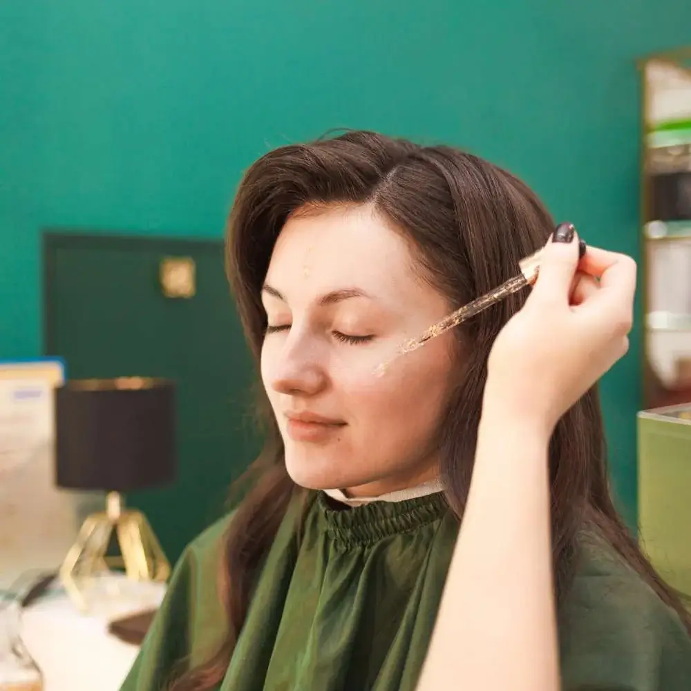 applying a dollop of makeup primer onto skin