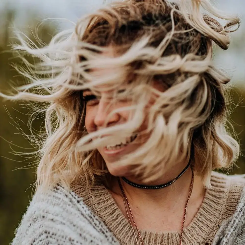 Woman admiring her new balayage hair