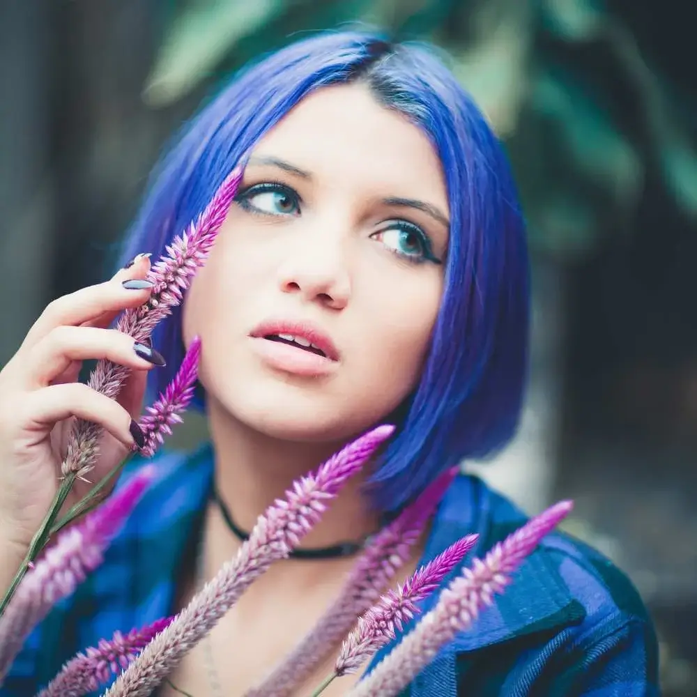 Woman with perfectly dyed blue hair enjoying the sunlight