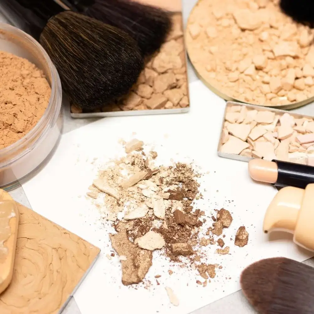 A variety of makeup primers spread out on a marble counter, showcasing the diversity of types available for different skin concerns