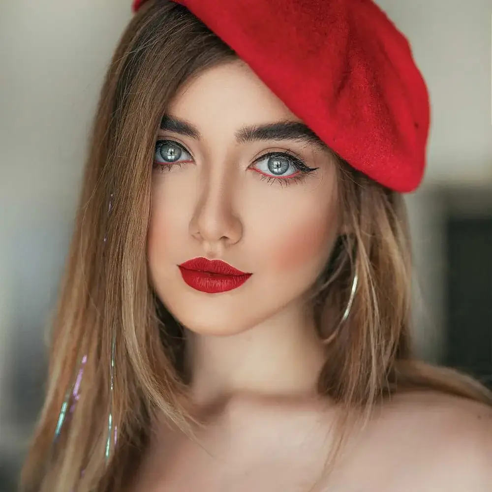 Woman posing confidently with her perfectly styled red lipstick