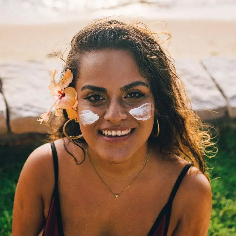 Woman applying sunscreen to her face 