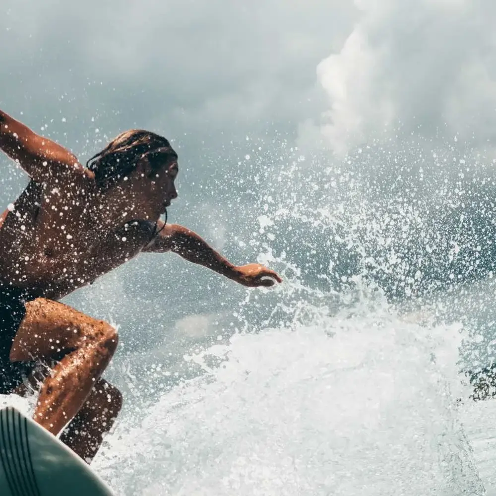 Surfer applying sunscreen before hitting the waves