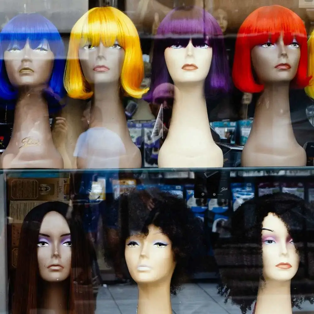 Various human hair wigs displayed, showcasing different styles and colors