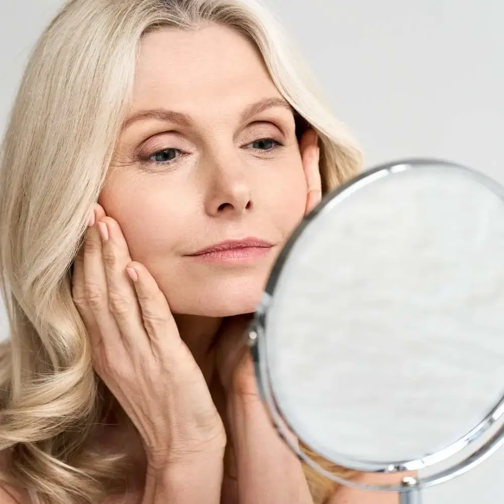 Woman applying an AHA product to enhance her skin complexion
