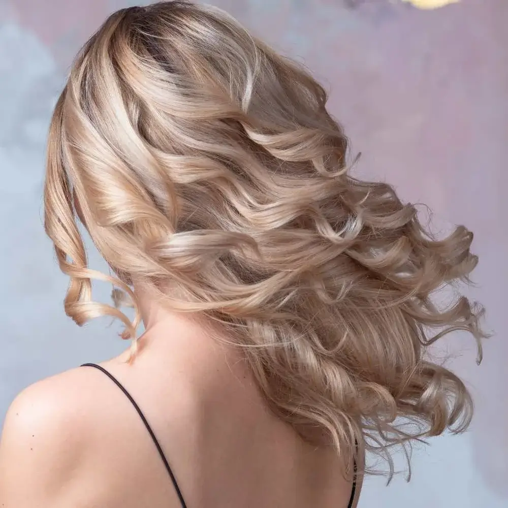 Woman confidently flaunting her perfectly curled fine hair