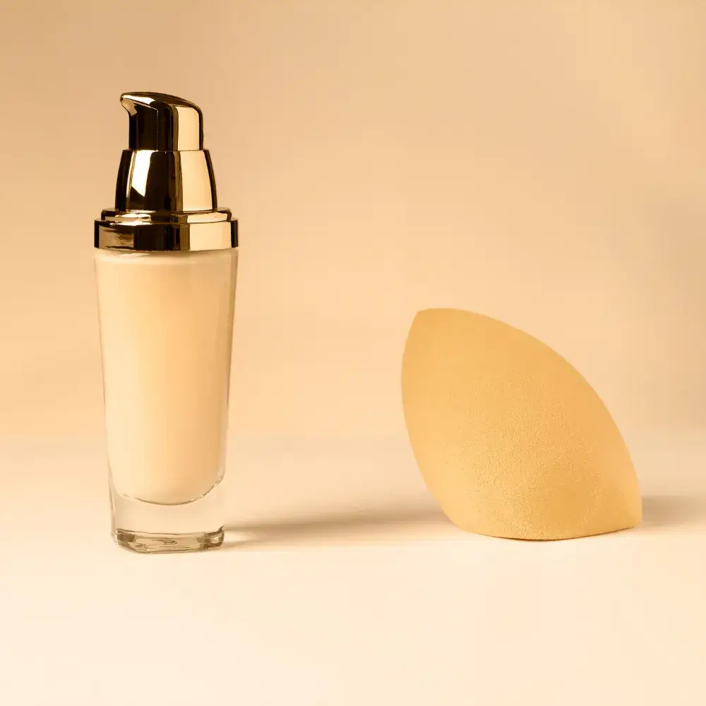 liquid foundation in a bottle and a sponge applicator