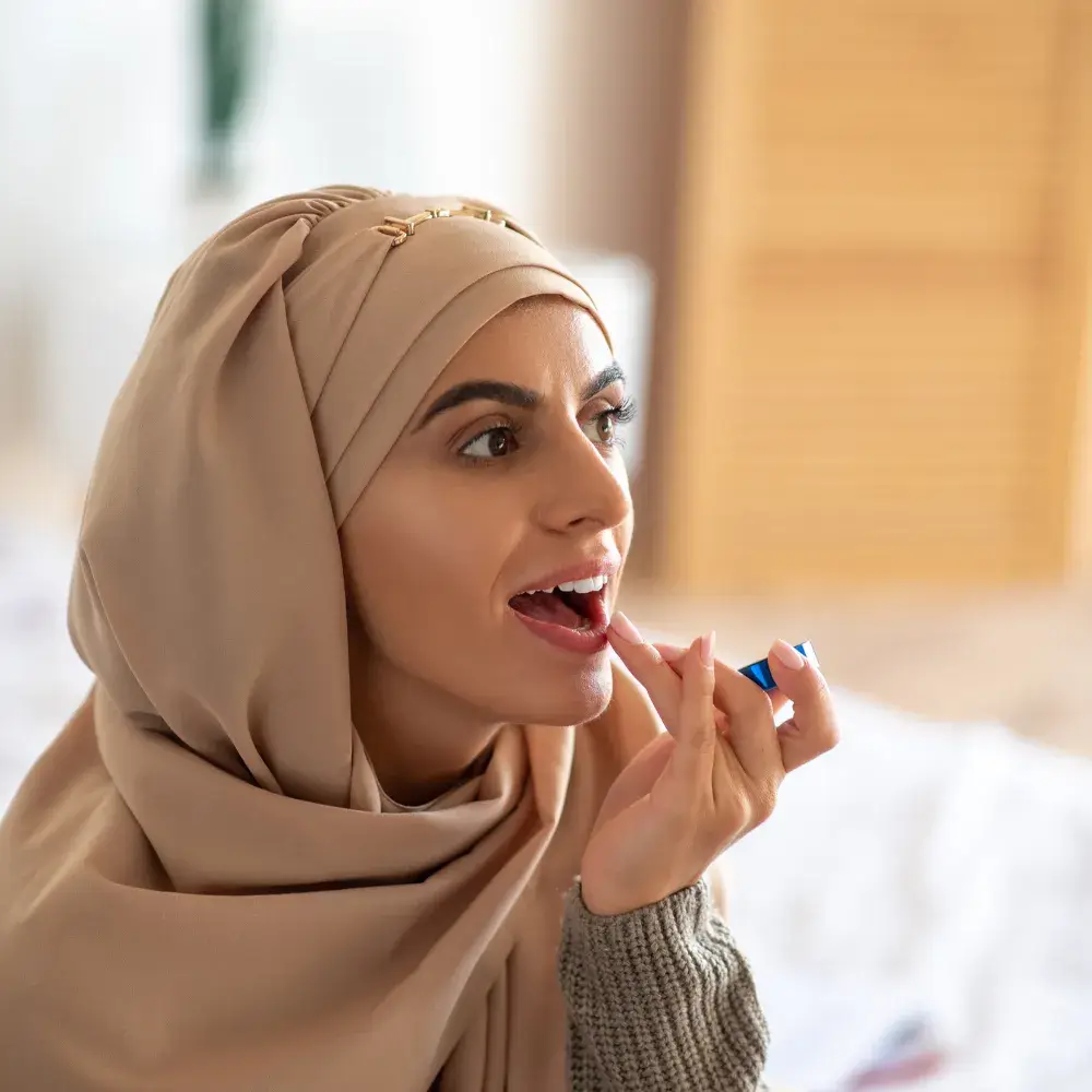 woman applying lip moisturizer