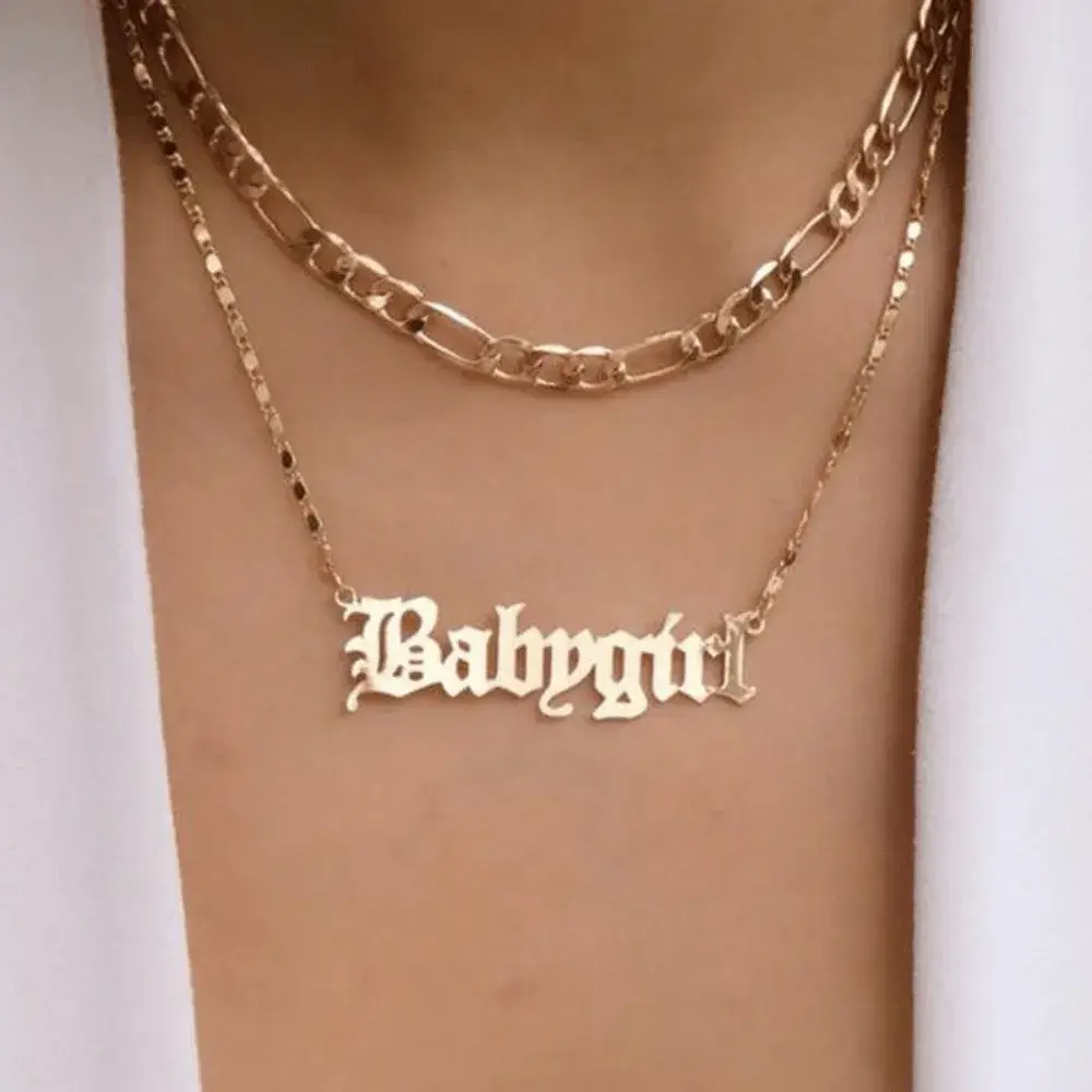 gold babygirl necklace on a woman's neck