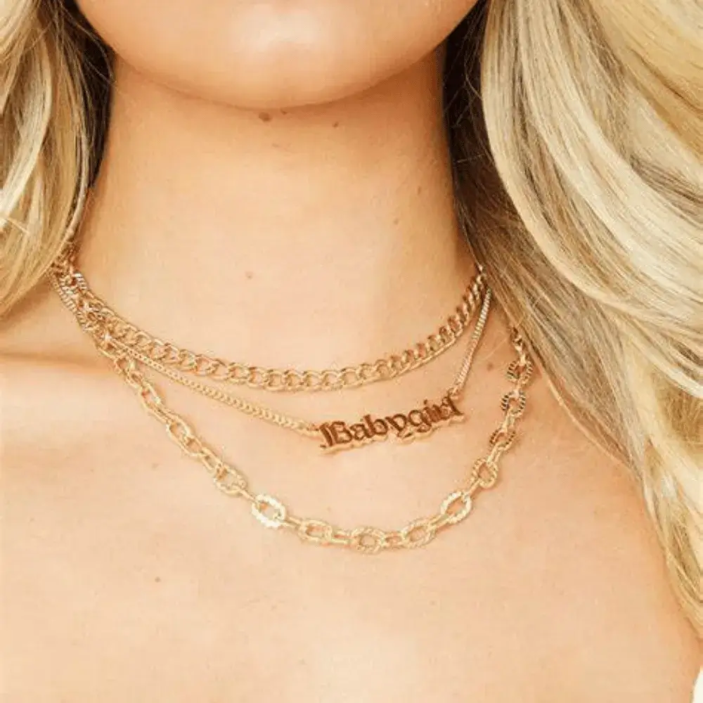 blonde woman wearing three chain necklaces