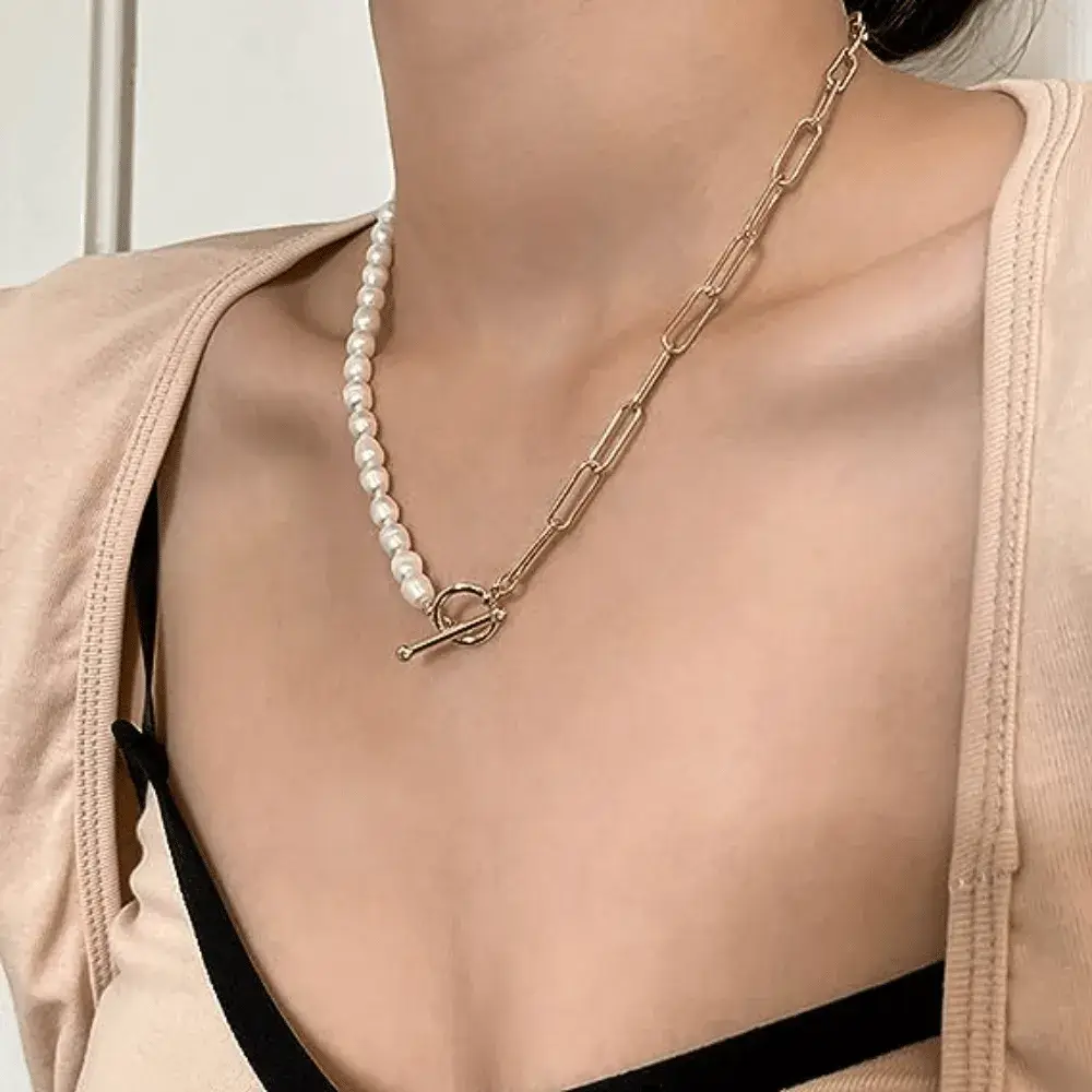 Half pearl half chain necklace on a woman's neck