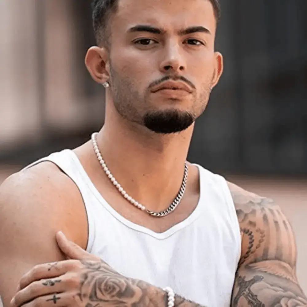 man wearing a half pearl half chain necklace