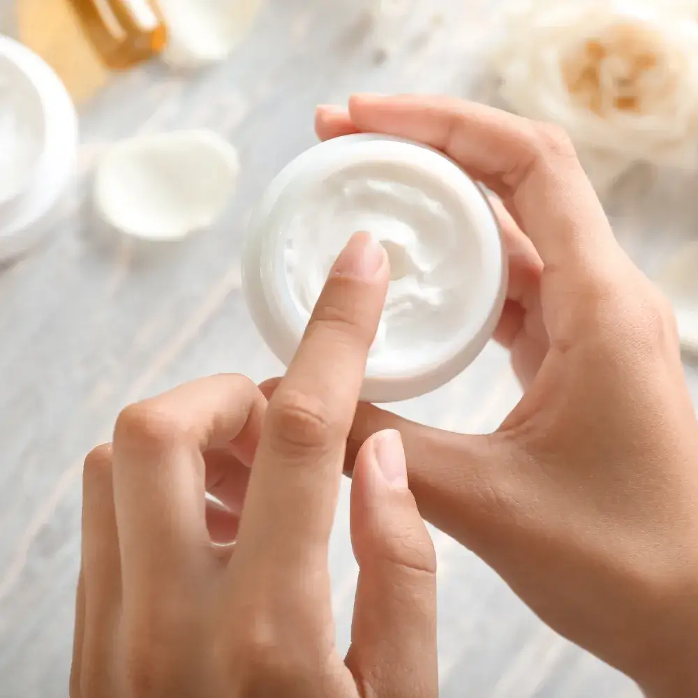 close up of hand holding an organic face moisturizer