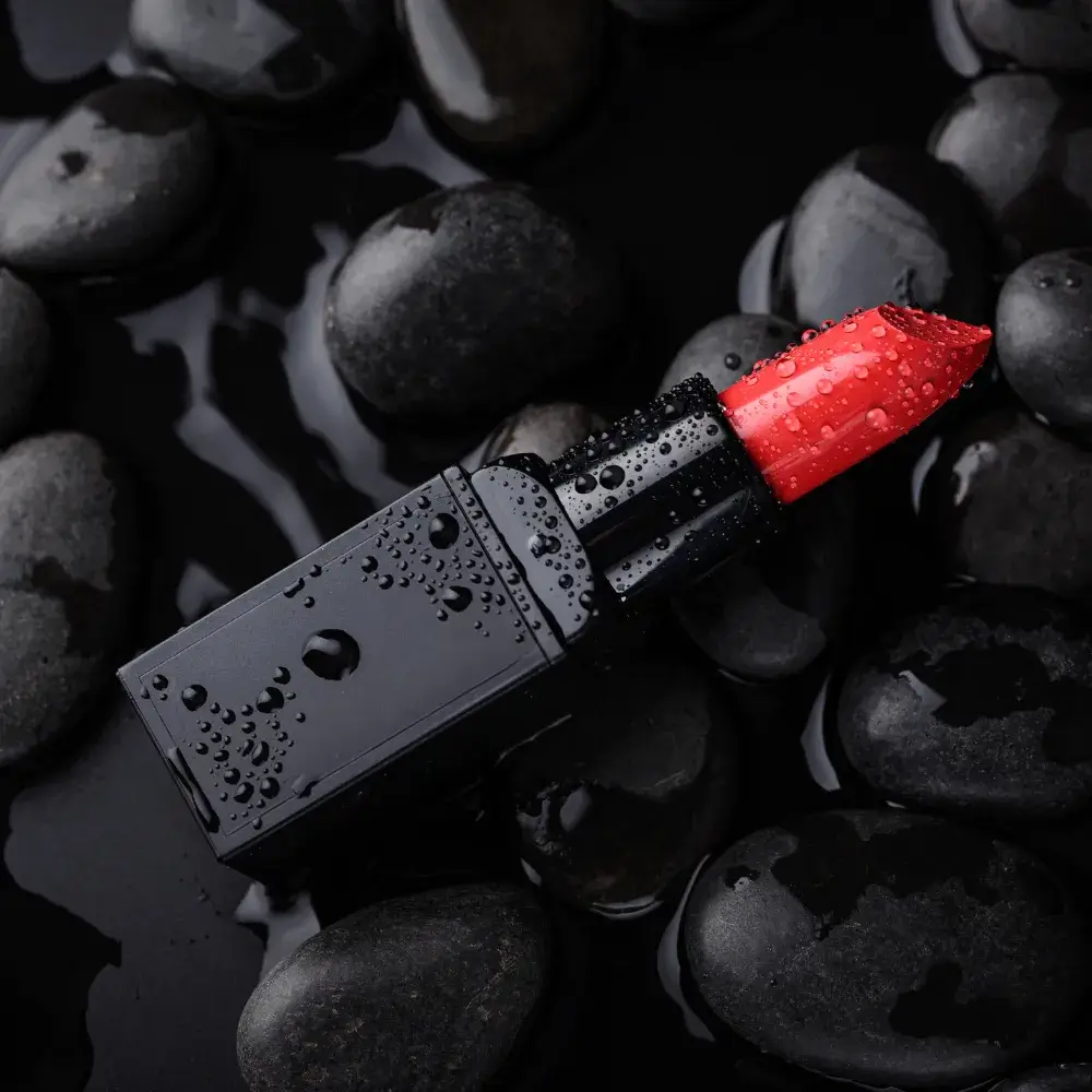 red lipstick on black stones