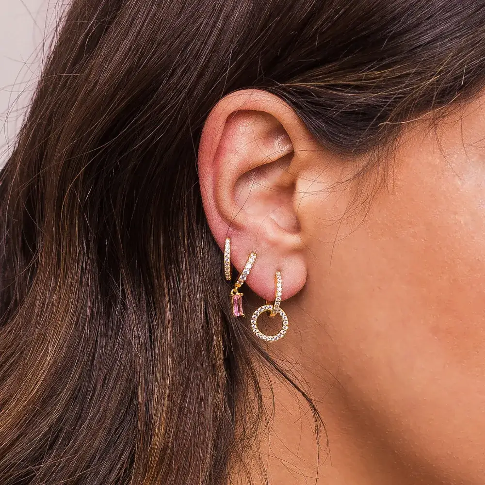 close up of a woman's ear with earrings