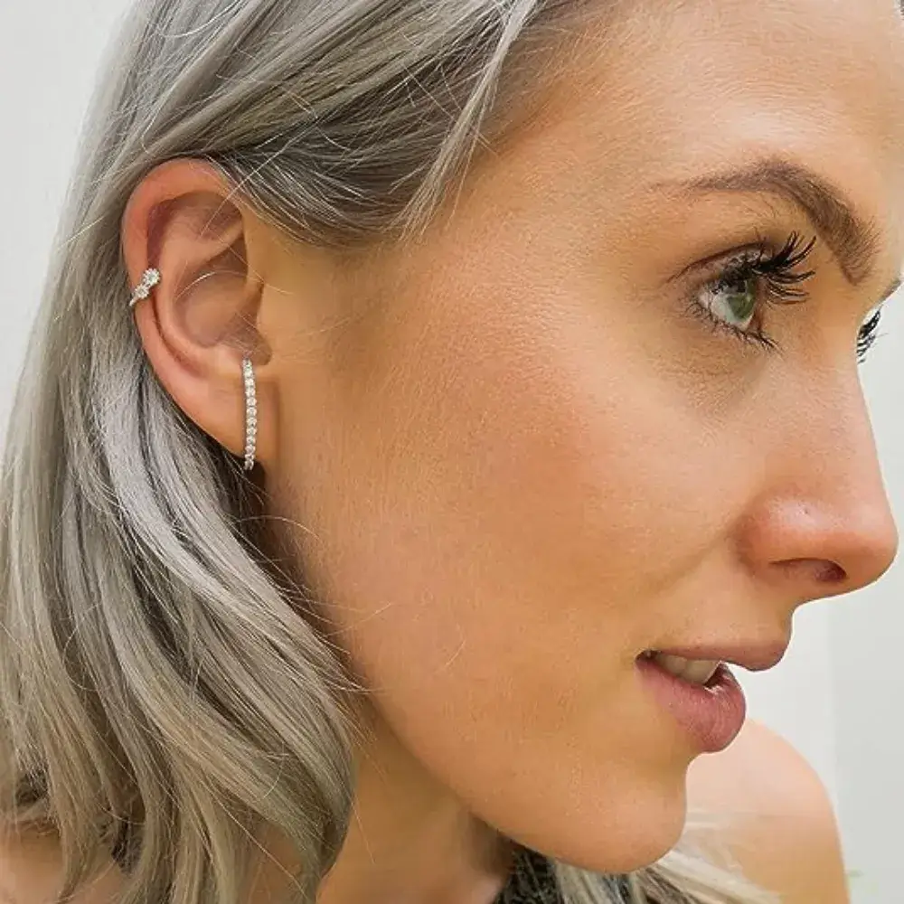 close up of a woman wearing suspender earrings
