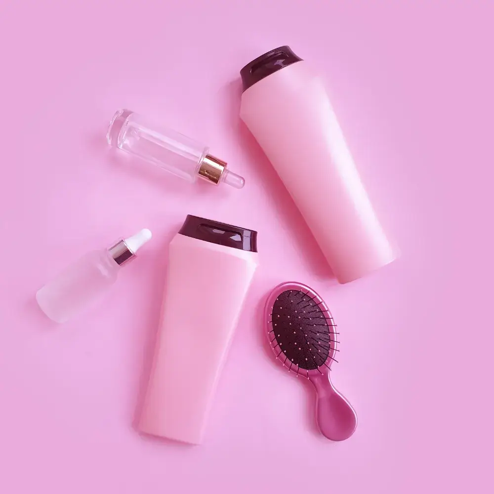 pink hair care products with pink background