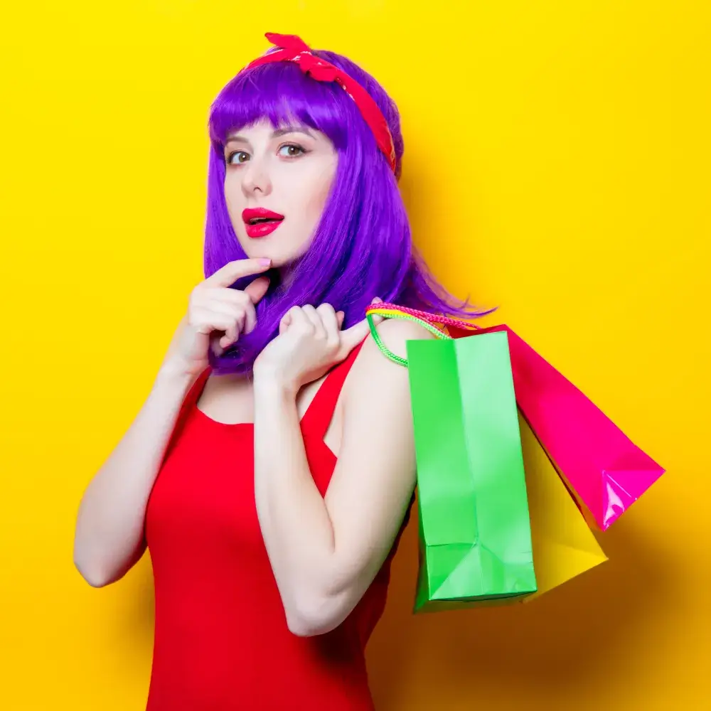 woman with purple wig holding colorful paper bags