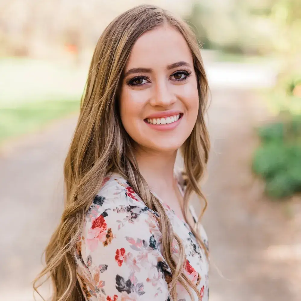 smiling woman with make up in a floral dress