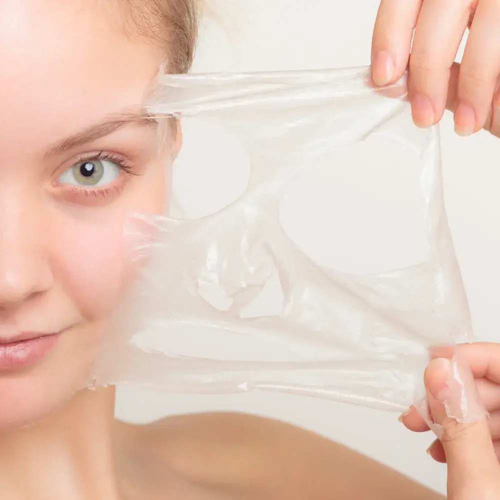 woman removing peel off face mask