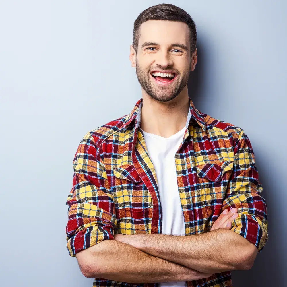 portrait of a man smiling wearing plaid shirt