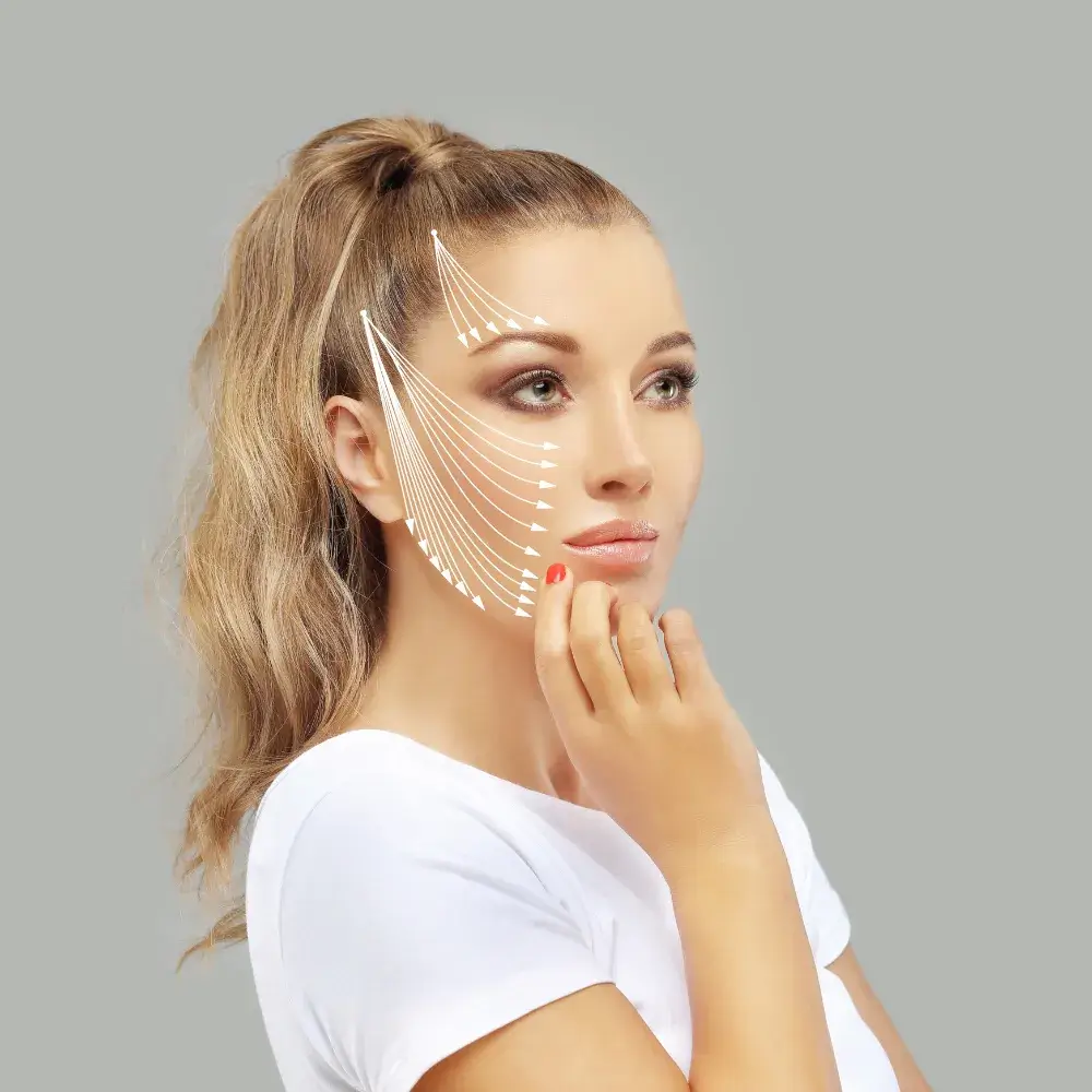 portrait of a brunette woman in a white shirt with arrows on her face indicating face lift