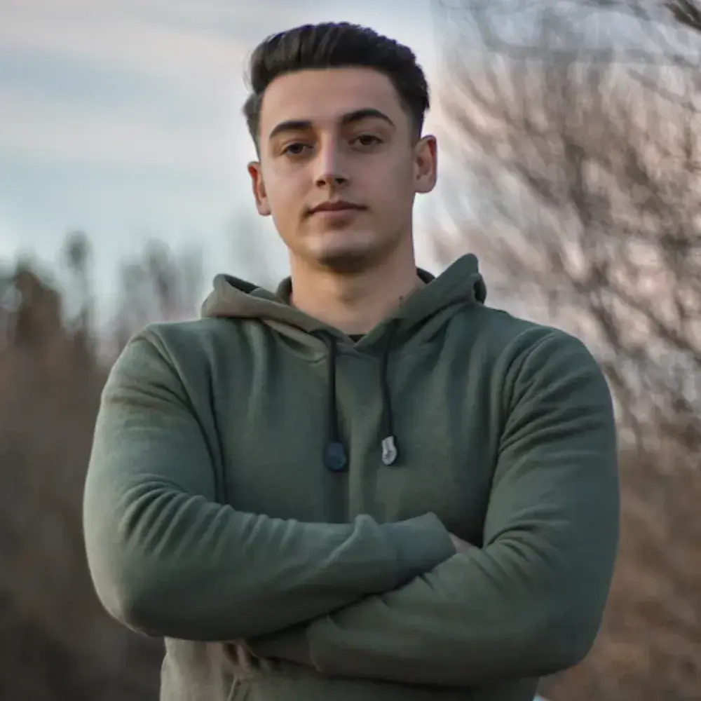 young man wearing a hoodie outdoors