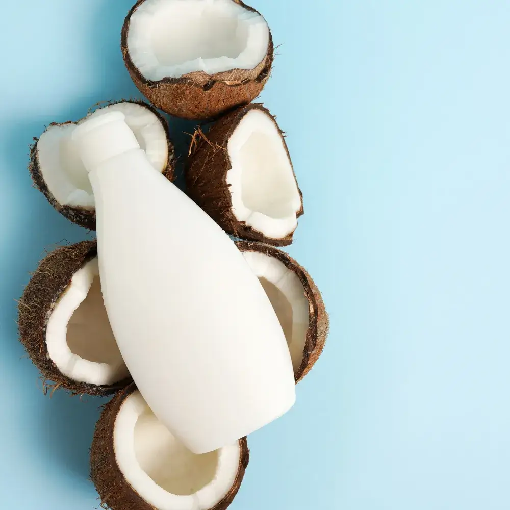 cosmetic product in white container with fresh coconuts 