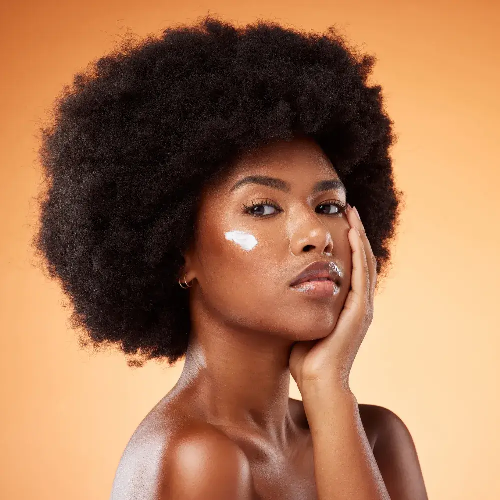 black woman with moisturizing cream on her face