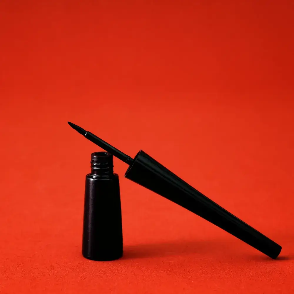 black drugstore eyeliner against the red background