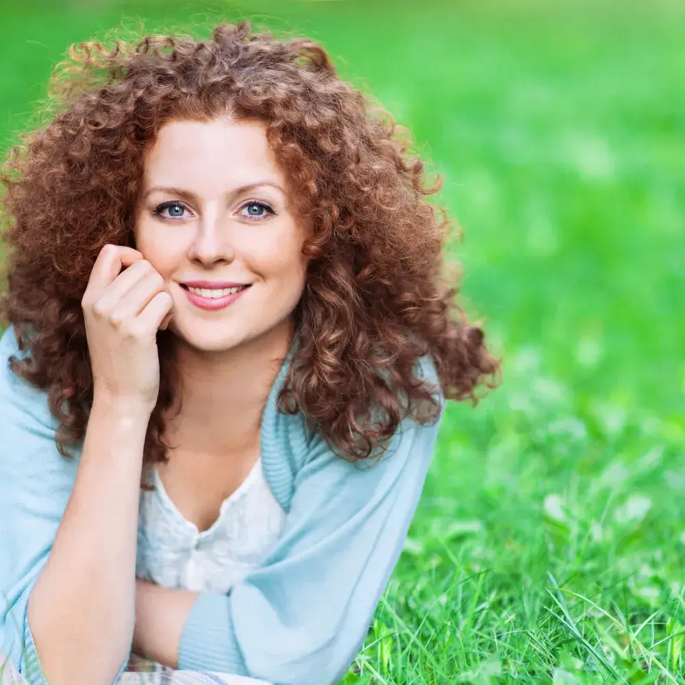 beautiful curly woman smiling outdoors