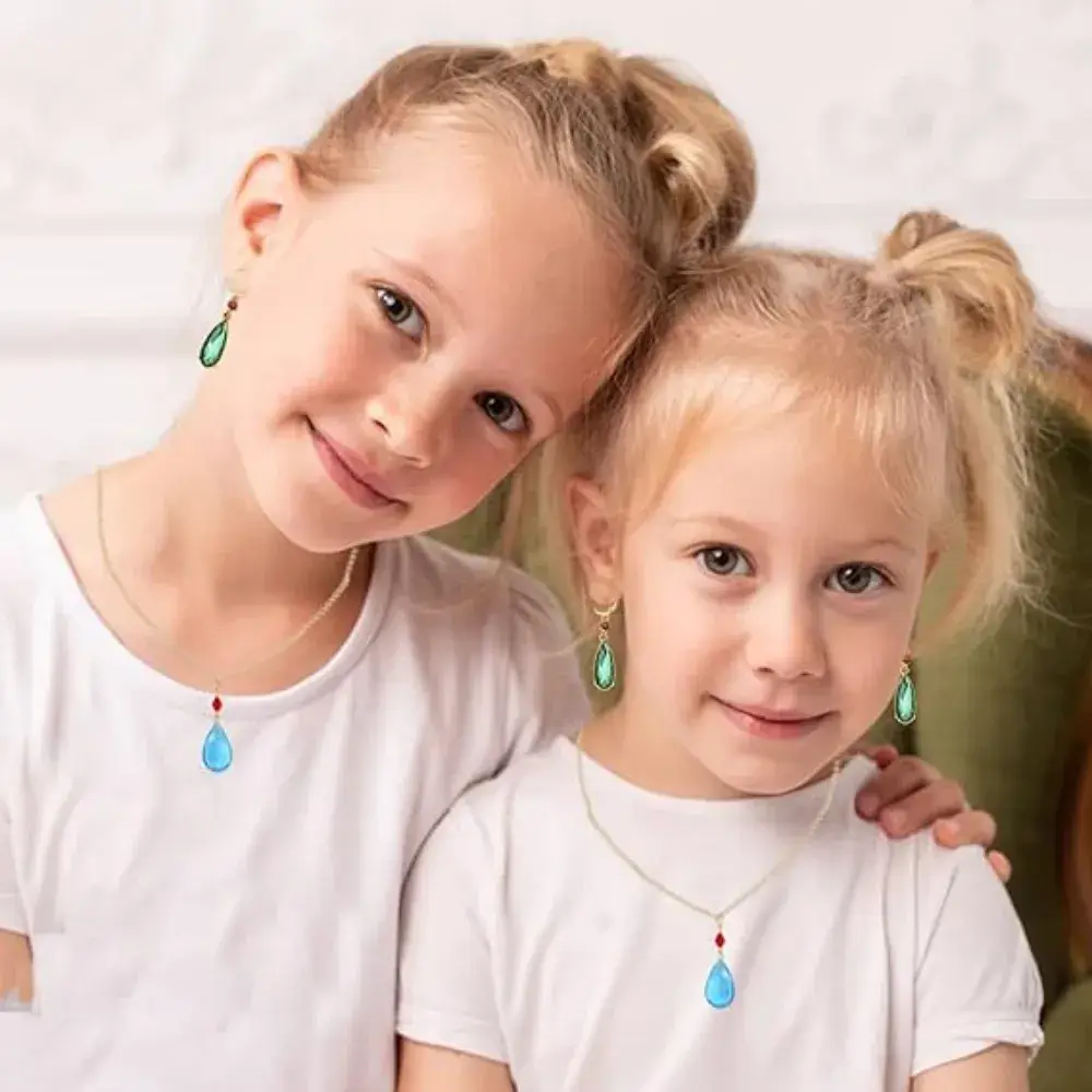 two little girls wearing howls necklaces and earrings