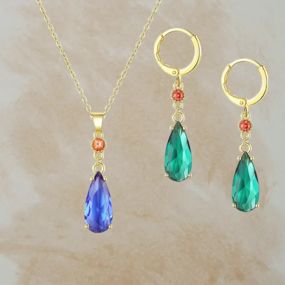 blue violet howls necklace and a pair of emerald green earrings