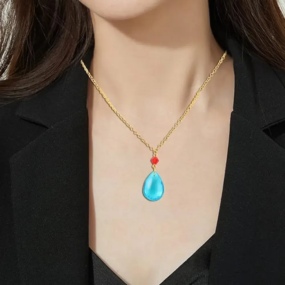 close up  of a woman's neck with howls necklace