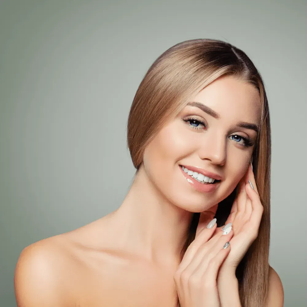 smiling brunette model with glossy lips and colored nails