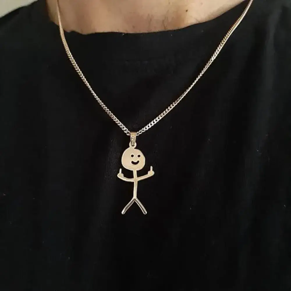 close up of a middle finger necklace on a man's black shirt