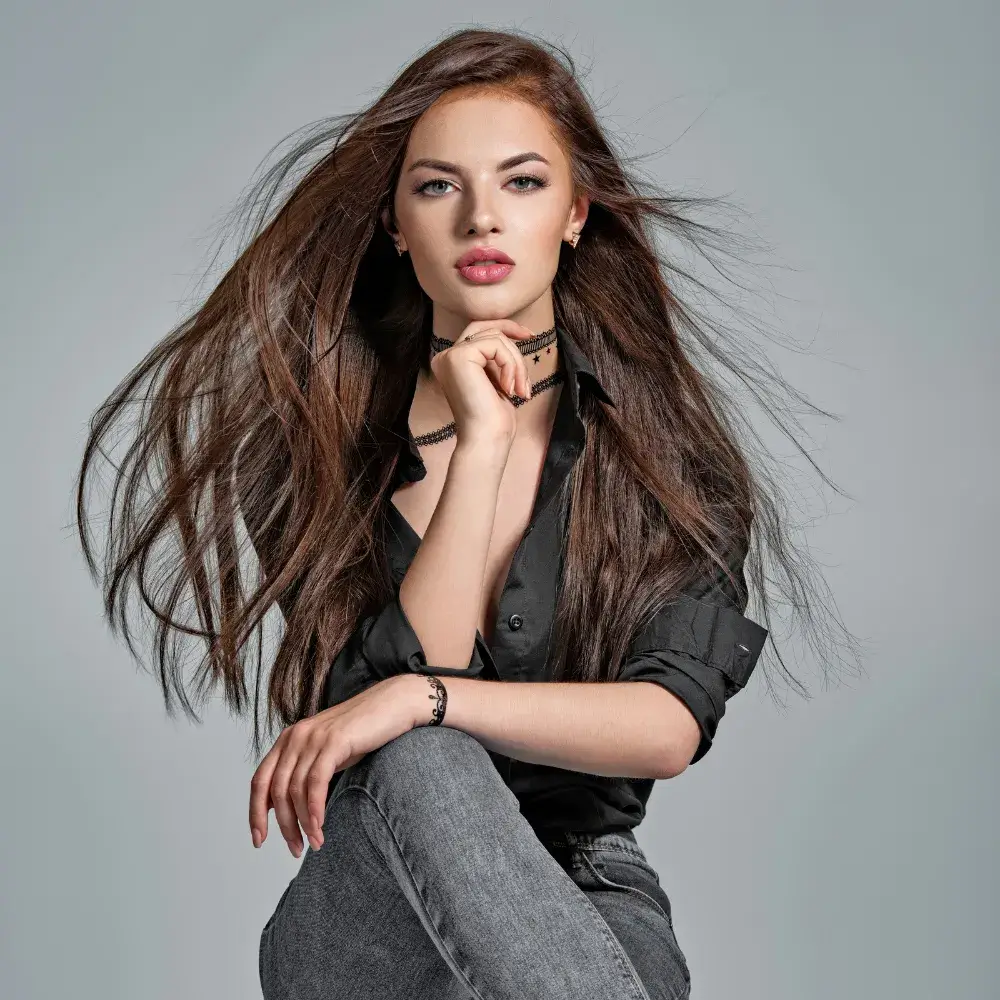 portrait of a sitting brunette woman in black shirt with long straight hair