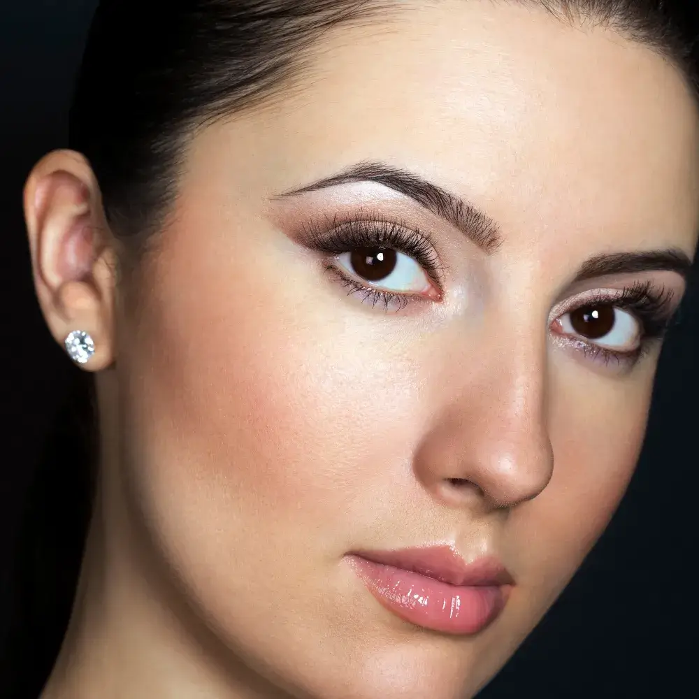 close up portrait of a woman with light makeup and thick lashes