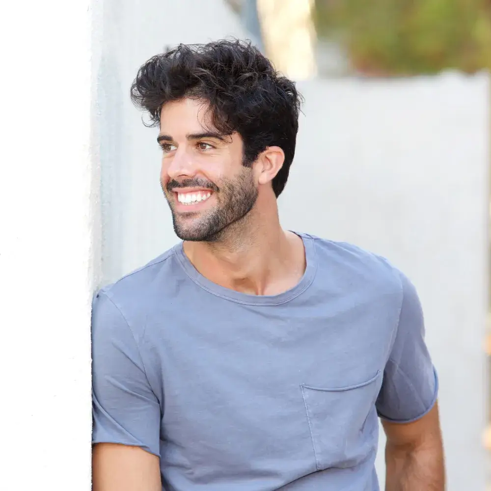 portrait of a smiling man in gray shirt