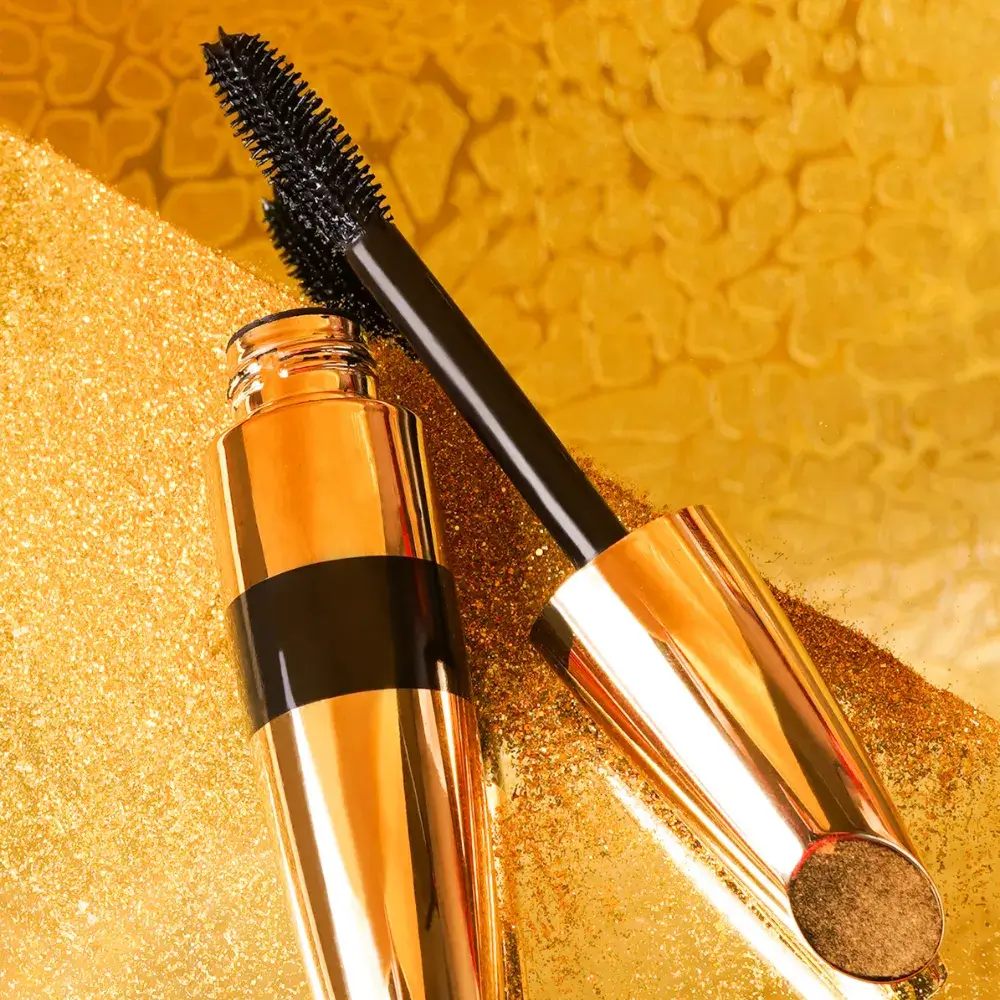 black mascara against a gold background