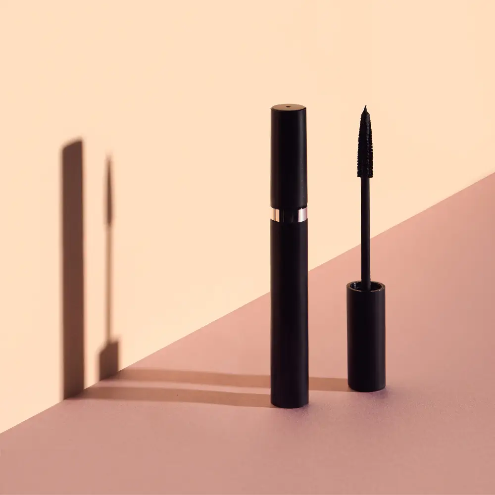 black mascara against a neutral-colored background