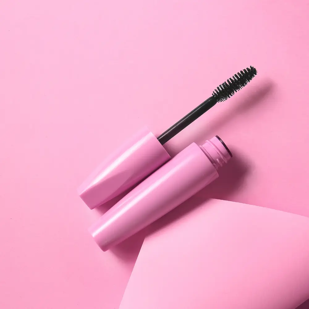 pink mascara against a pink background