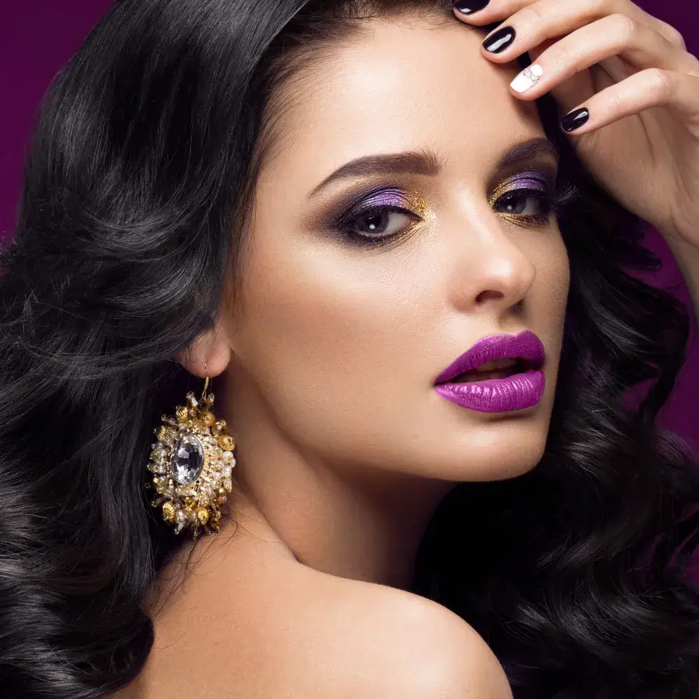 close up portrait of a woman with smokey purple eyeshadow and purple lipstick