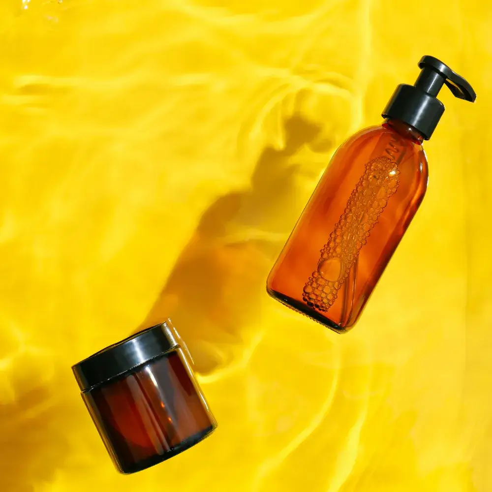 cosmetic products on the water with yellow background
